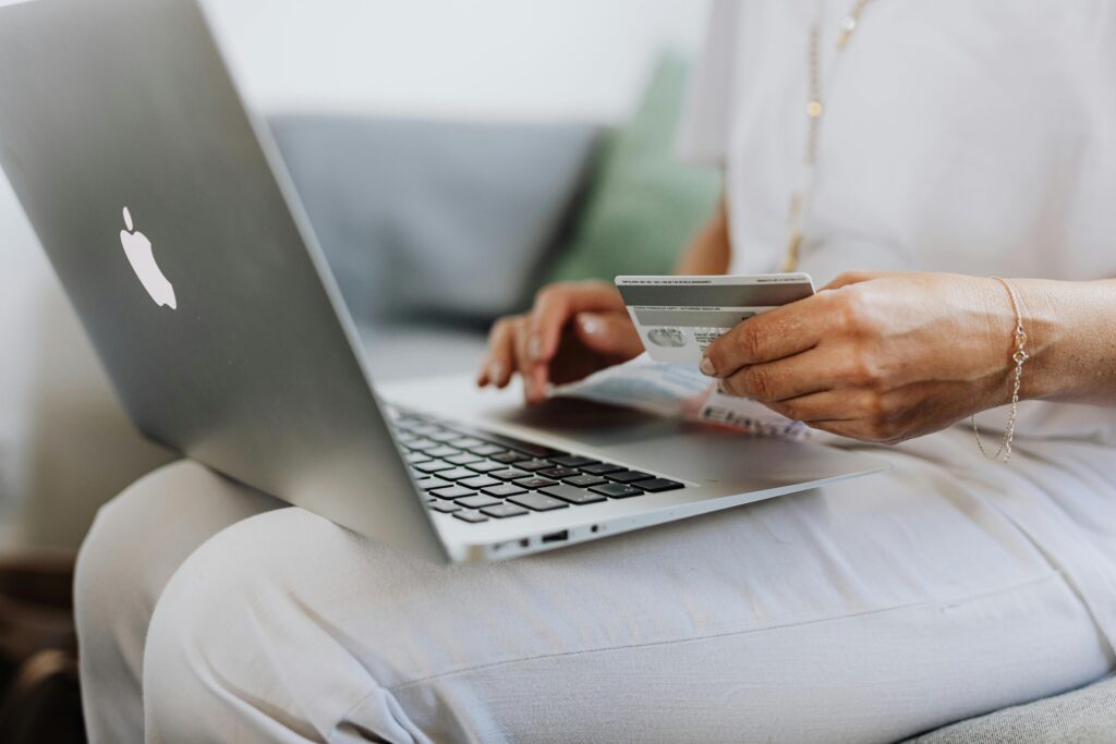 pexels-photo-4968391-4968391 Person Using a Macbook and Holding a Credit Card